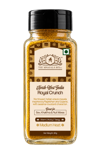 The Mmasala Box Co. North-West India Royal Crunch snack masala in a glass spice jar with black cap, professionally photographed on a clean white background.
