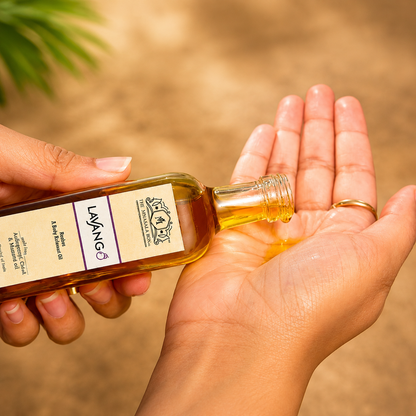 Close-up of Lavang Body Relaxant Oil being poured onto hands for a soothing body massage, highlighting the natural wellness oil’s calming and nourishing properties.